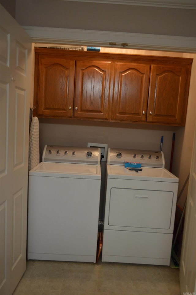 washroom featuring cabinet space and separate washer and dryer