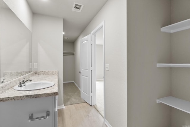 16 Sig Cv, Ward, AR 72176 - bathroom featuring vanity, wood finished floors, and baseboards