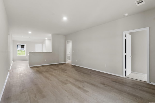 16 Sig Cv, Ward, AR 72176 - unfurnished living room featuring baseboards, light wood-style flooring, and recessed lighting