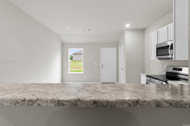 16 Sig Cv, Ward, AR 72176 - kitchen with stainless steel appliances, white cabinetry, recessed lighting, and light stone counters