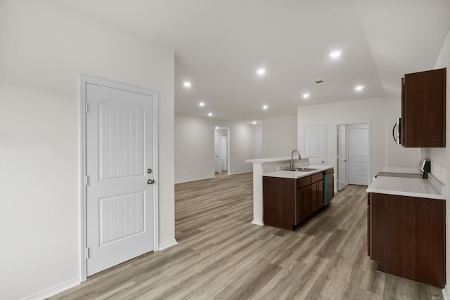 kitchen featuring a sink, stainless steel appliances, light wood-style flooring, light countertops, and recessed lighting