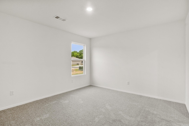 carpeted empty room featuring baseboards and recessed lighting