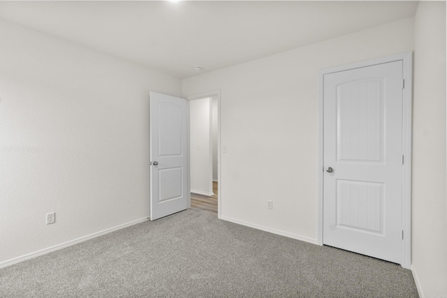 unfurnished bedroom with carpet floors and baseboards