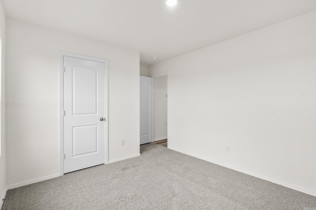 unfurnished bedroom with carpet, baseboards, and recessed lighting