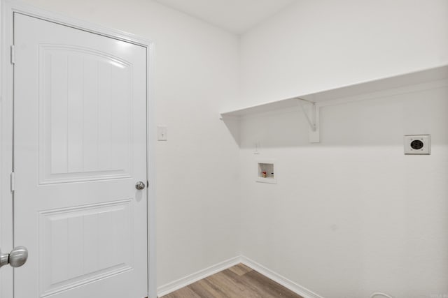 clothes washing area with light wood-type flooring, washer hookup, electric dryer hookup, and baseboards
