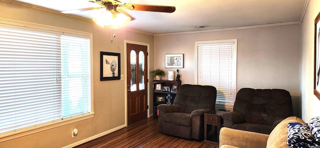 sitting room with dark wood finished floors, plenty of natural light, baseboards, and ornamental molding