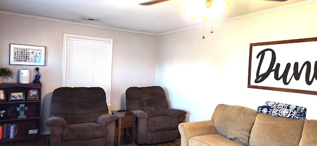 living room with ceiling fan and ornamental molding