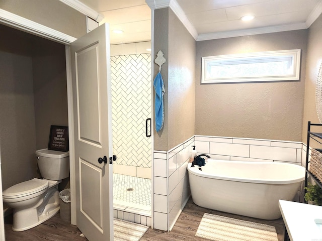 bathroom featuring a stall shower, wood finished floors, a soaking tub, and ornamental molding