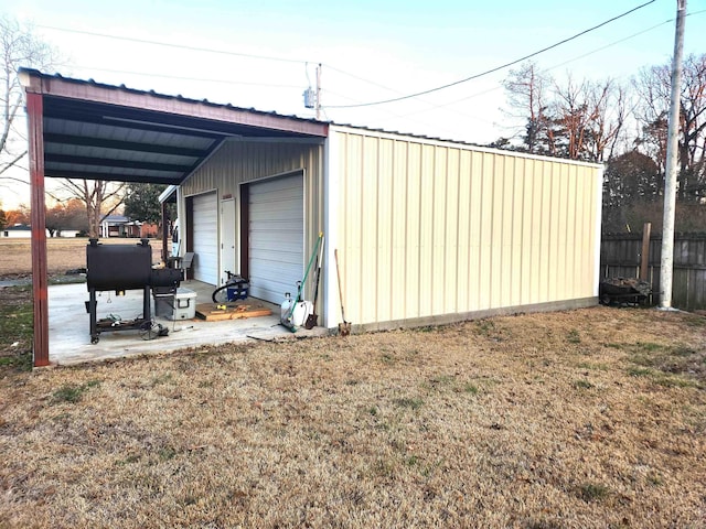 view of outbuilding featuring an outdoor structure and fence