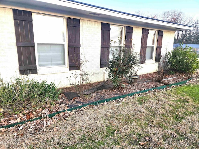 view of side of property with brick siding