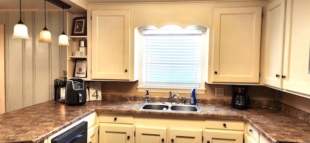 kitchen with dark countertops, decorative light fixtures, black dishwasher, and a sink