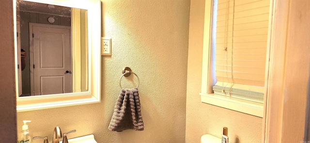 bathroom with a textured wall