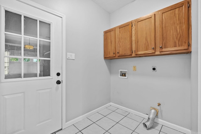 laundry area with baseboards, light tile patterned floors, hookup for a washing machine, cabinet space, and hookup for an electric dryer