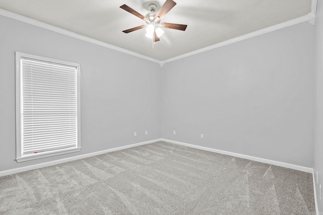 unfurnished room with ceiling fan, baseboards, ornamental molding, and carpet flooring