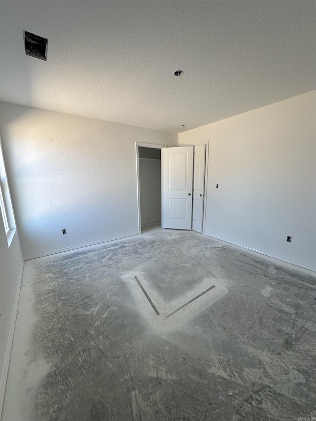28 Doe Run Dr, Ward, AR 72176 - unfurnished bedroom with concrete flooring and a textured ceiling