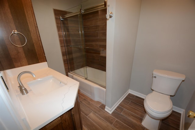 116 Nickels St, Hot Springs, AR 71913 - full bath with baseboards, wood finish floors, bath / shower combo with glass door, toilet, and vanity