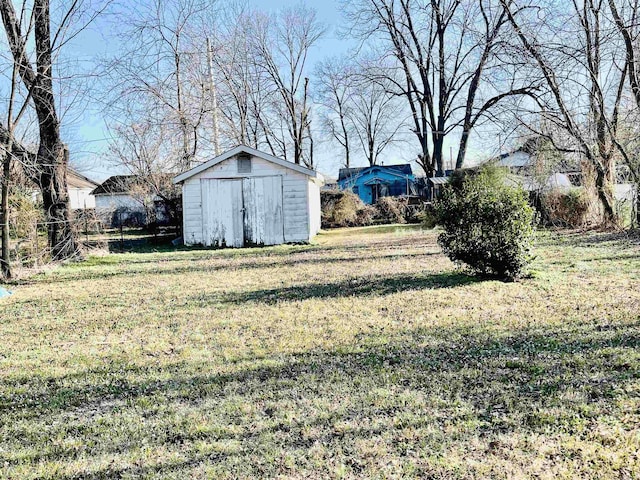 view of yard with an outbuilding and a shed