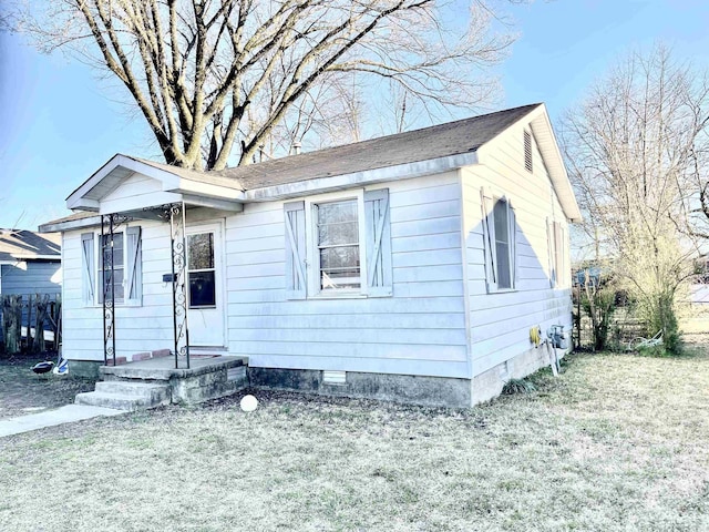 bungalow with a front yard, fence, and crawl space