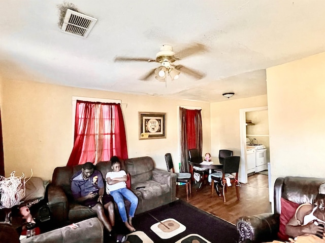 living area with visible vents and ceiling fan