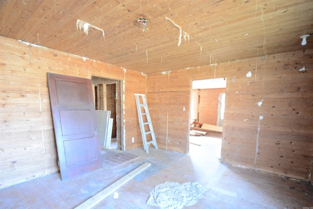 empty room with wooden walls and wooden ceiling