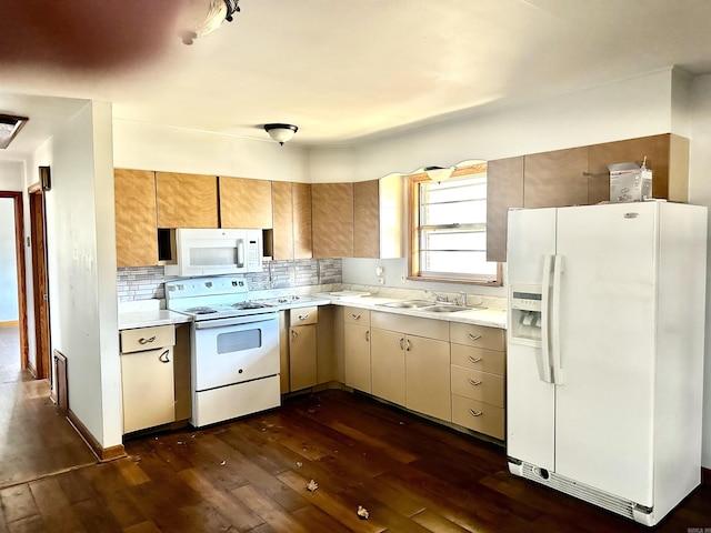 kitchen with white appliances, light countertops, dark wood-type flooring, and a sink