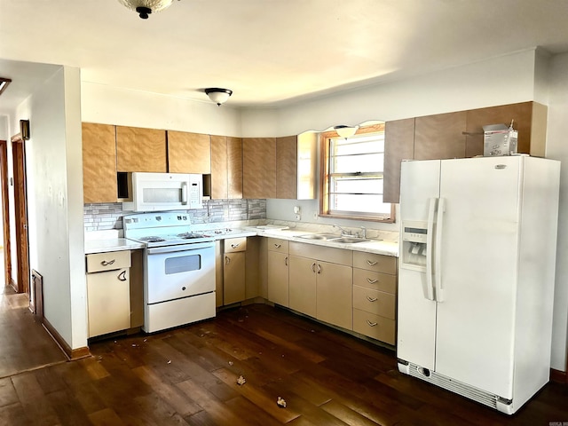 kitchen featuring white appliances, light countertops, dark wood-style flooring, and a sink