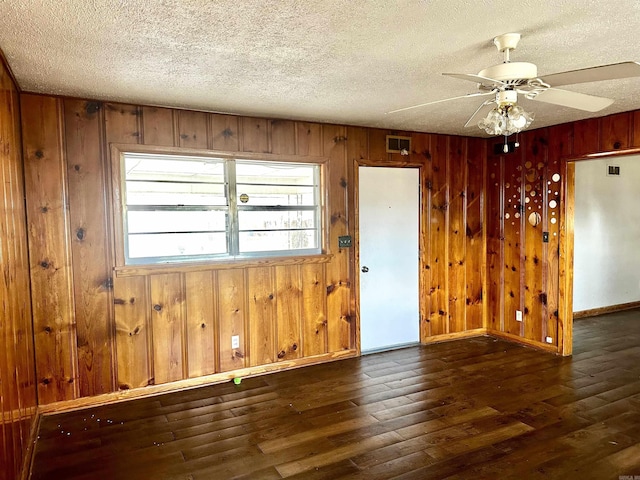 empty room featuring hardwood / wood-style flooring and a textured ceiling