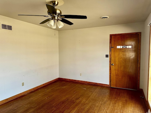 spare room with visible vents, baseboards, and hardwood / wood-style floors