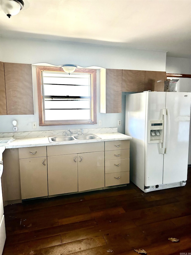 kitchen with a sink, dark wood-type flooring, and white fridge with ice dispenser