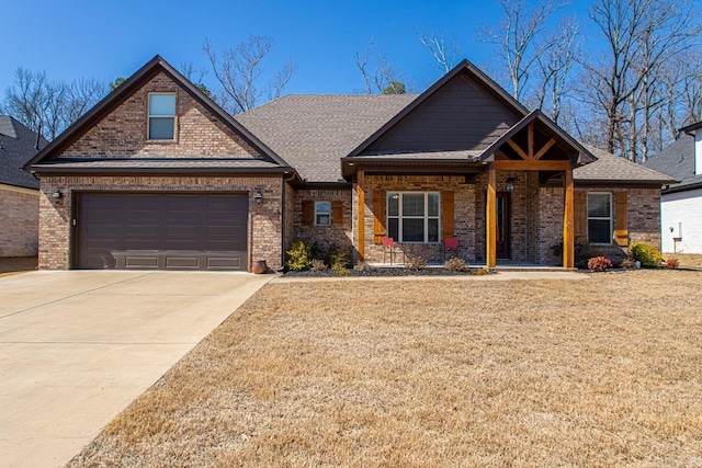 craftsman inspired home with driveway, an attached garage, a shingled roof, a front lawn, and brick siding