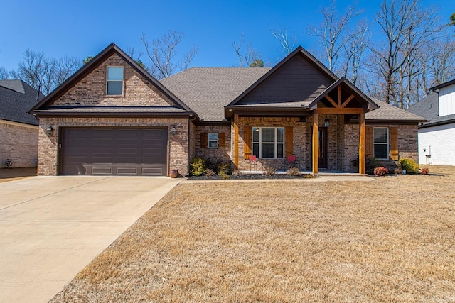 craftsman-style house with a front yard, an attached garage, brick siding, and concrete driveway