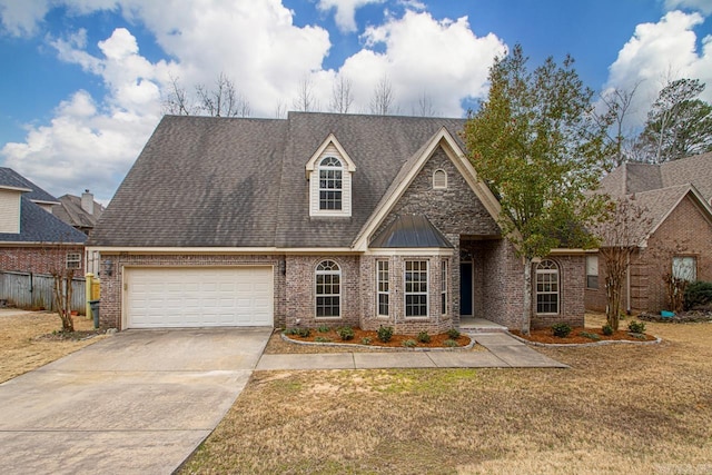 view of front of home featuring brick siding, concrete driveway, a front yard, roof with shingles, and a garage