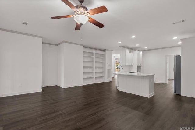 unfurnished living room featuring visible vents, dark wood-type flooring, and ornamental molding