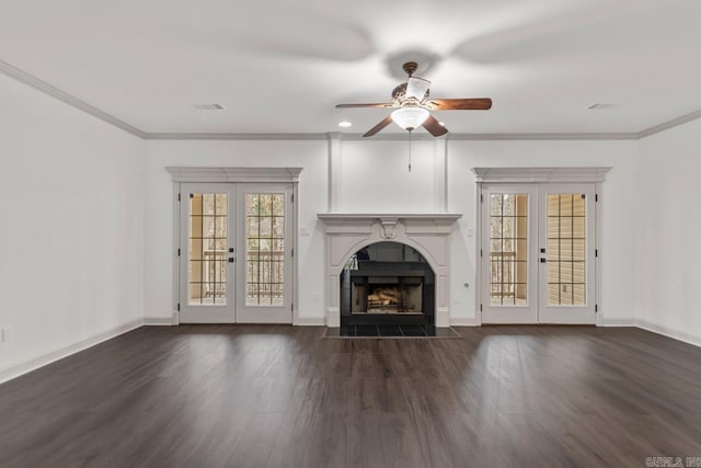 unfurnished living room featuring a fireplace with flush hearth, french doors, crown molding, and wood finished floors