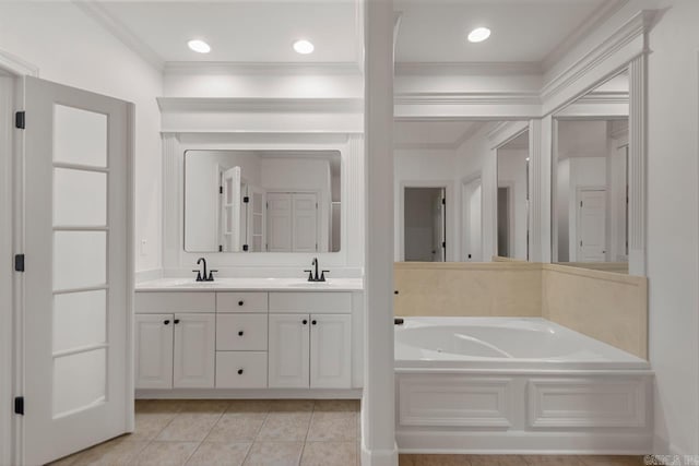 full bath with double vanity, a sink, ornamental molding, a garden tub, and tile patterned floors