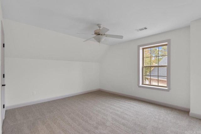 additional living space with visible vents, baseboards, lofted ceiling, and carpet floors