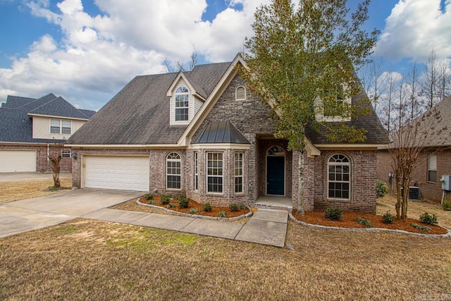 view of front of home with concrete driveway, a garage, brick siding, and a front lawn