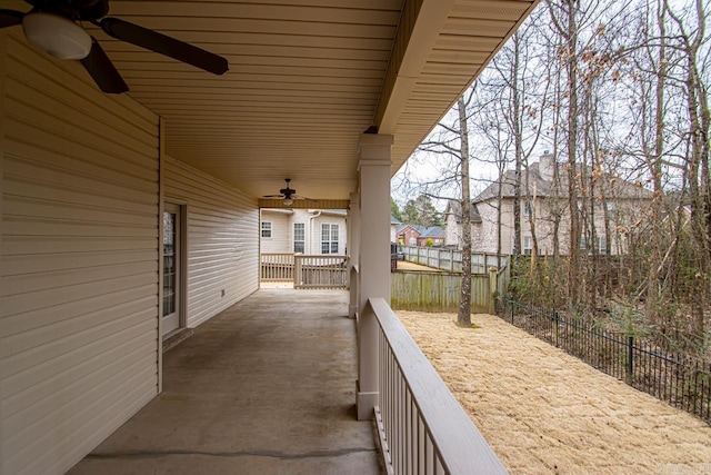 view of patio with ceiling fan and fence