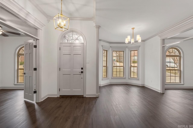 foyer entrance with baseboards, ceiling fan with notable chandelier, dark wood-style floors, and ornamental molding