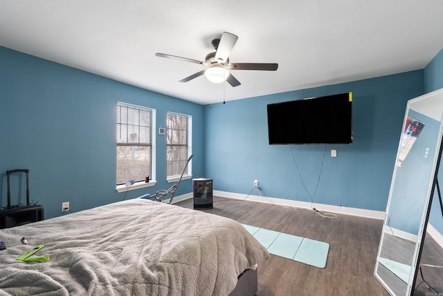 bedroom featuring wood finished floors, baseboards, and ceiling fan