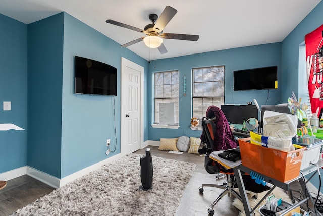 office area with wood finished floors, baseboards, and ceiling fan