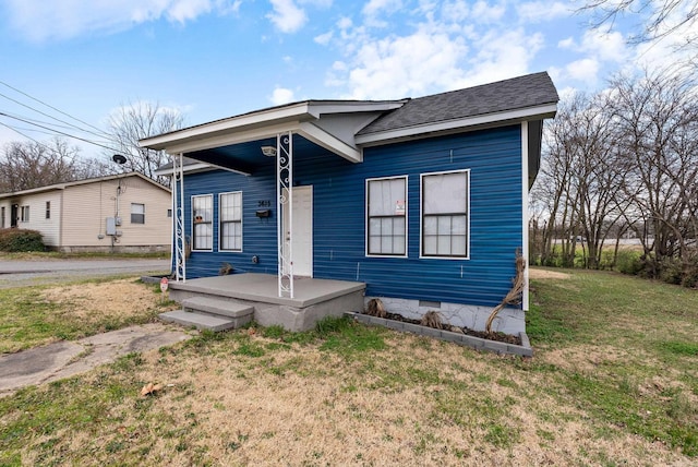 bungalow featuring a front yard, a porch, roof with shingles, and crawl space