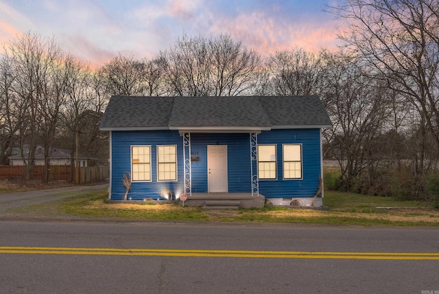 view of front of home featuring crawl space, driveway, a shingled roof, and fence