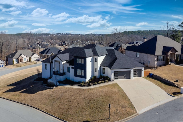 french country style house with concrete driveway, a garage, a residential view, and a front lawn