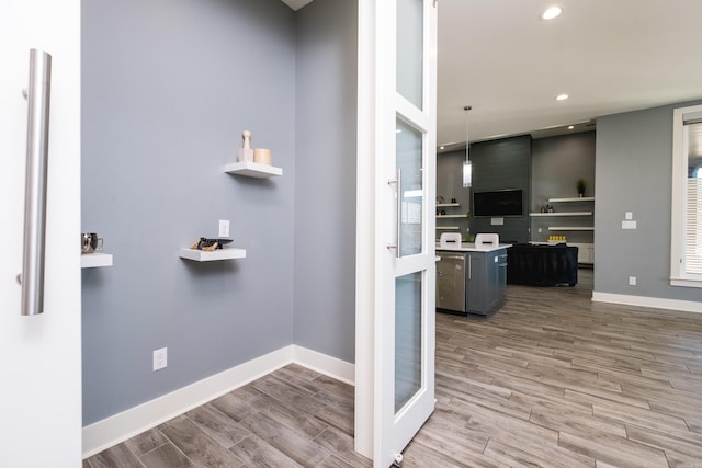 kitchen with recessed lighting, baseboards, wood finished floors, and light countertops