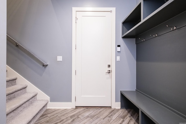 mudroom with light wood-style flooring and baseboards