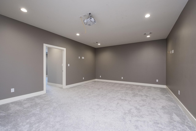 empty room with recessed lighting, light colored carpet, and visible vents