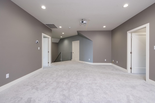 carpeted empty room with visible vents, recessed lighting, and baseboards