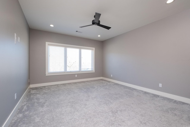 empty room with visible vents, recessed lighting, and baseboards