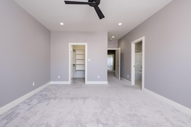 unfurnished bedroom featuring recessed lighting, carpet flooring, baseboards, and a spacious closet